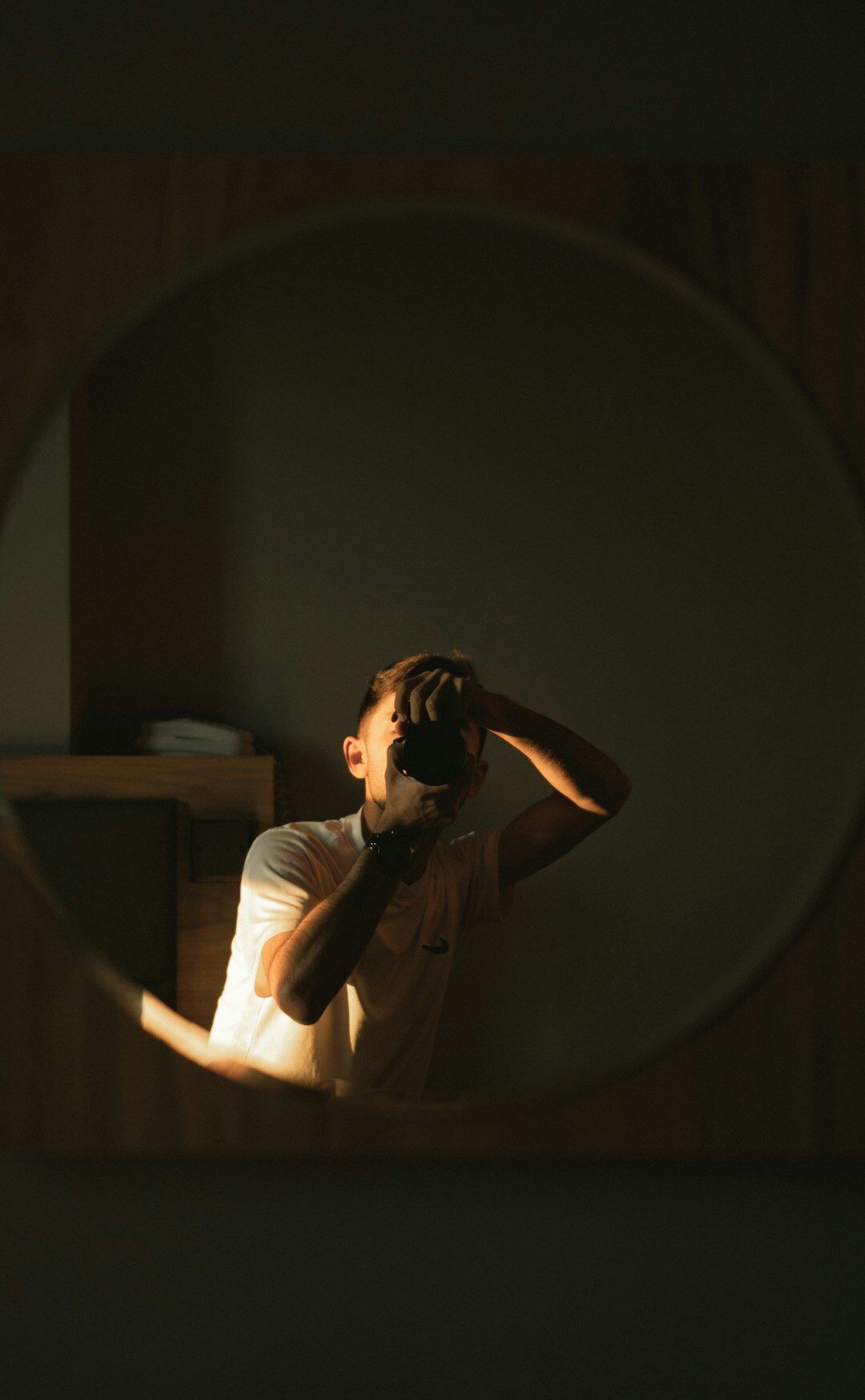 Person practicing a speech alone in front of a mirror