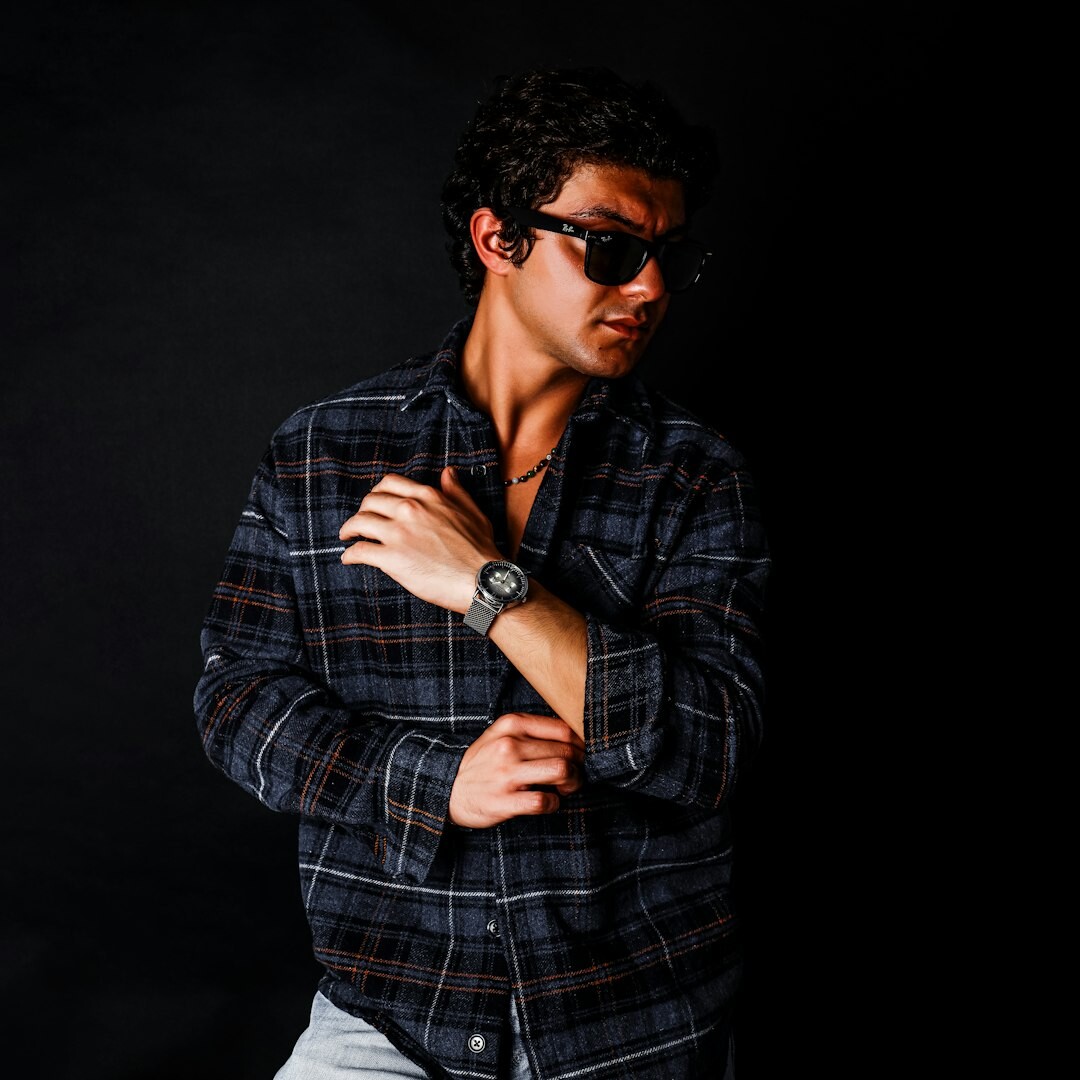 Studio portrait of an older Brazilian man with glasses
